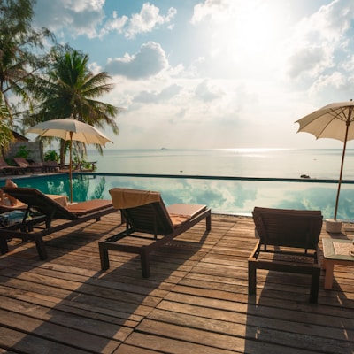 brown wooden lounge chairs on brown wooden dock during daytime