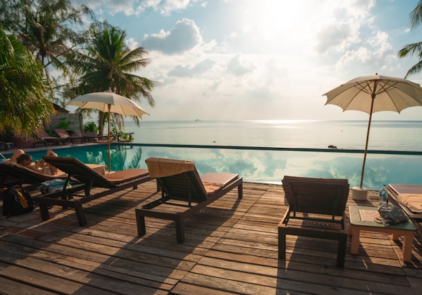 brown wooden lounge chairs on brown wooden dock during daytime