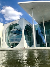 white concrete building near body of water during daytime