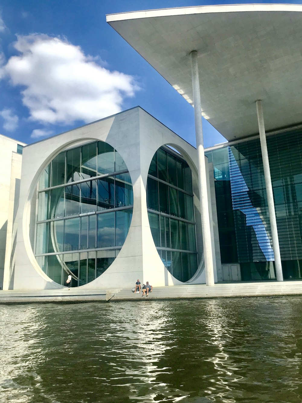 white concrete building near body of water during daytime