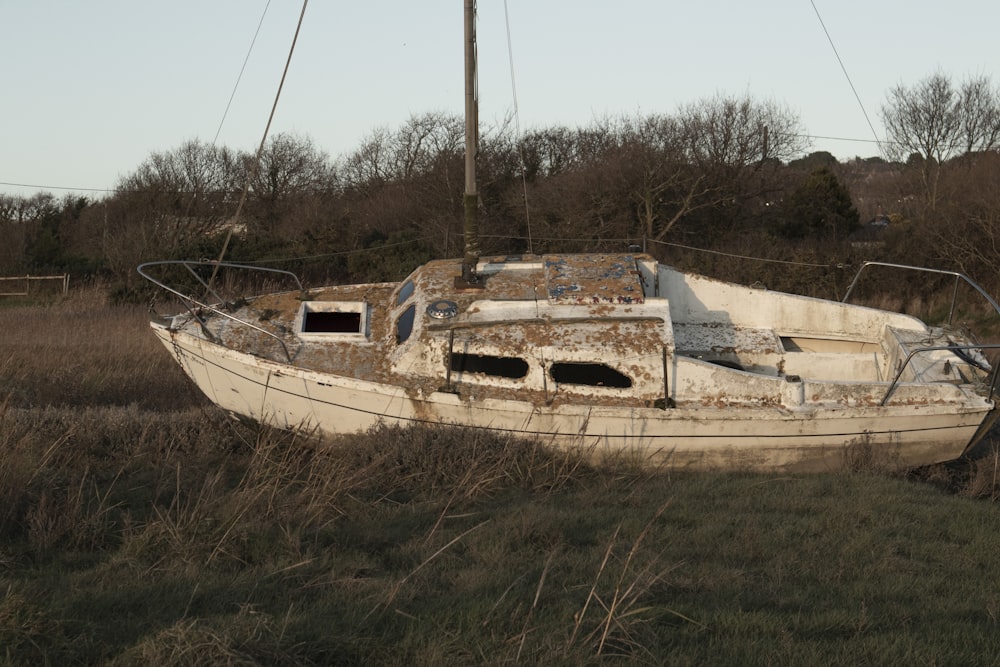 white and brown boat on brown soil during daytime