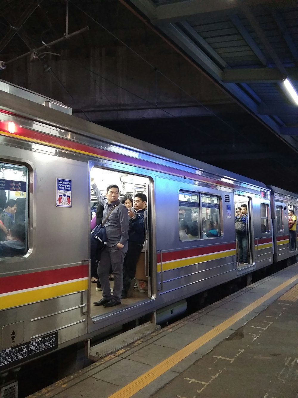 people standing in train station