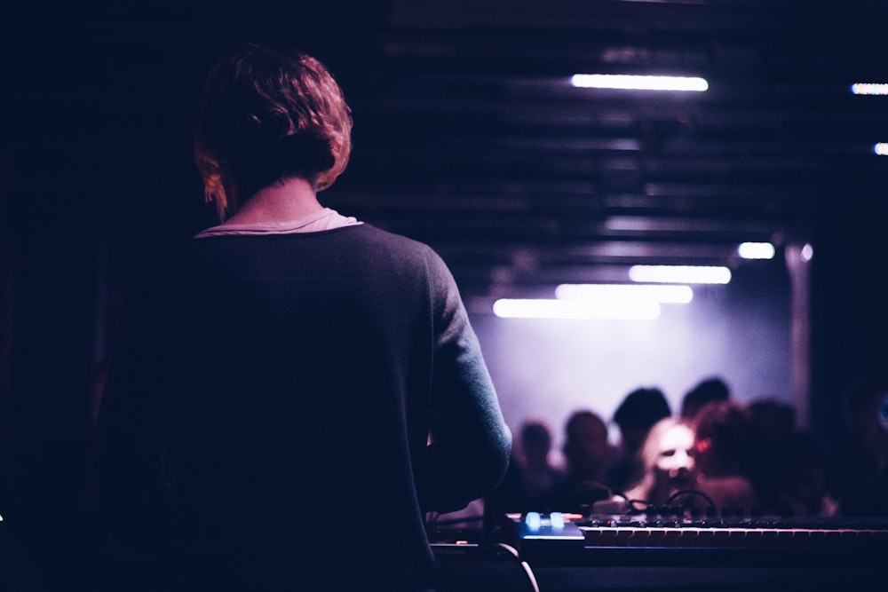 man in black long sleeve shirt standing in front of people