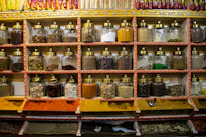Shelves stocked with a variety of fresh spices, grains, and traditional Indian ingredients.