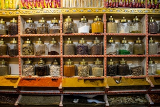 Colorful jars of spices and condiments lined up on shelves