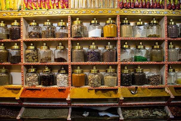 A beautifully arranged display of premium spices in elegant glass jars.