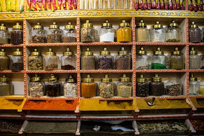 Rows of aromatic spices and herbs in traditional containers.