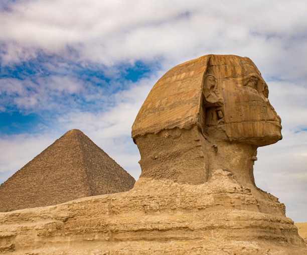 brown concrete statue under blue sky during daytime