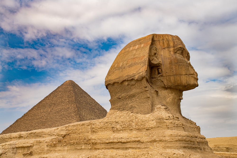 brown concrete statue under blue sky during daytime