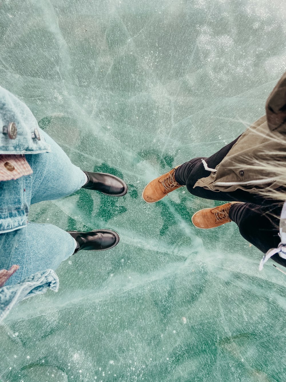 person in brown pants and brown shoes standing on water