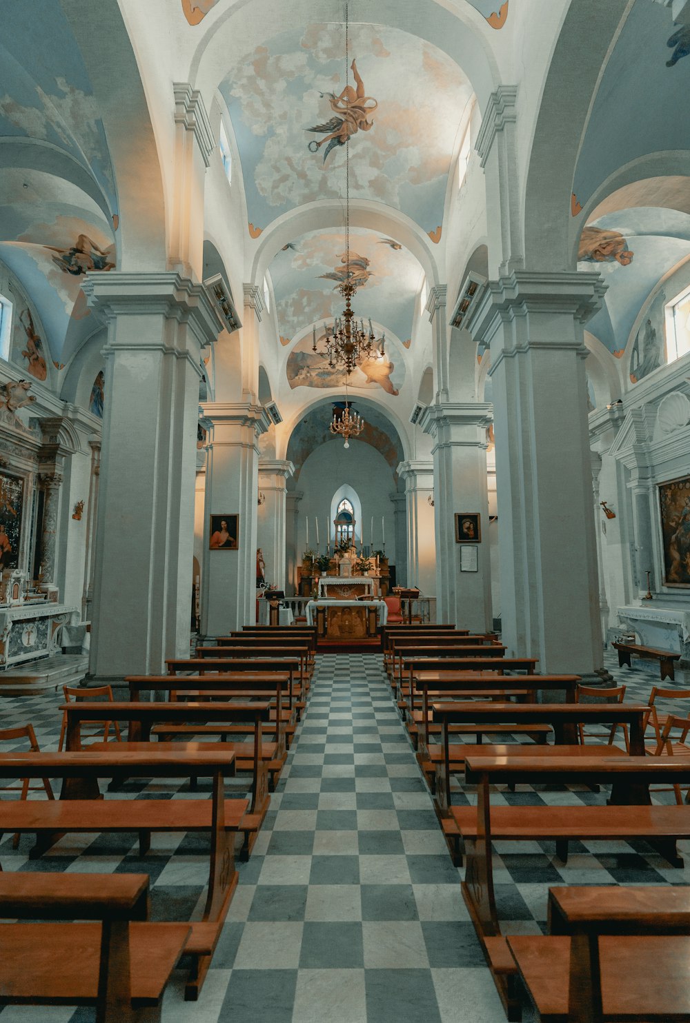 brown wooden chairs inside white and gray cathedral