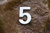 white letter p on brown textile