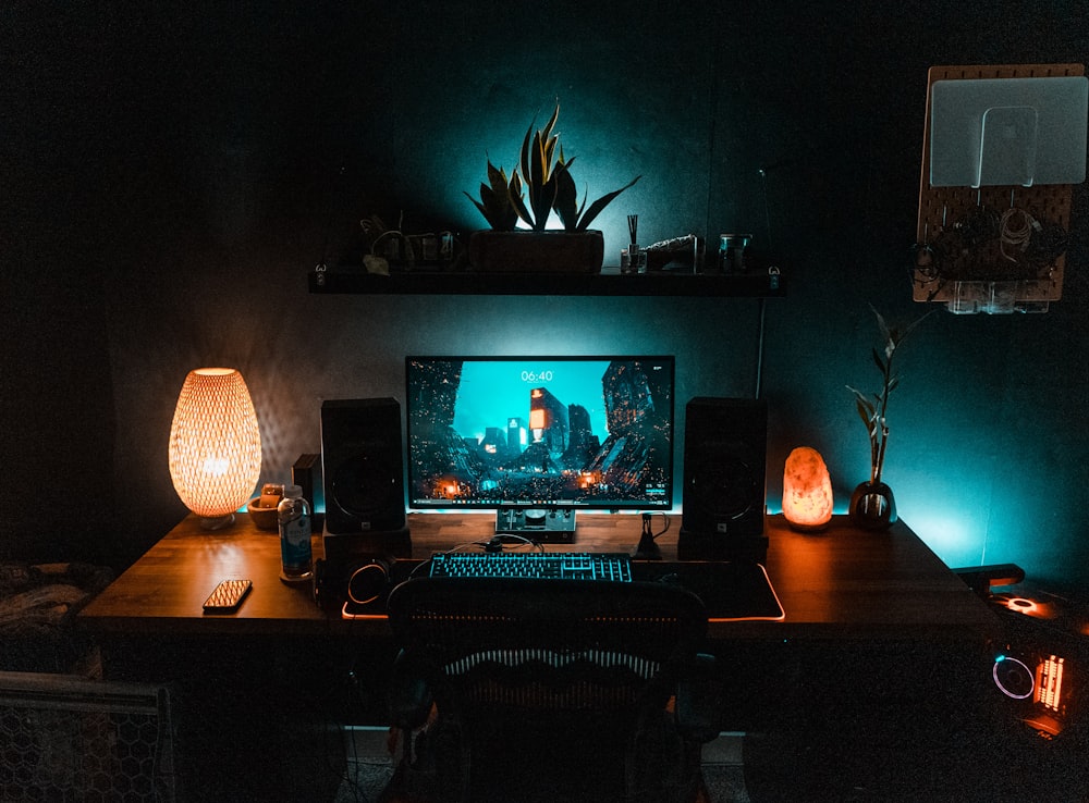 black flat screen computer monitor on brown wooden desk