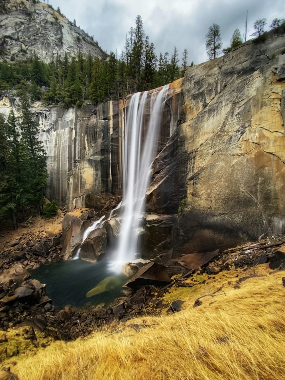 waterfalls in the middle of the forest during daytime