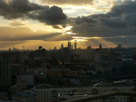 A cinematic still from a recent indie film featuring a dramatic cityscape at dusk.