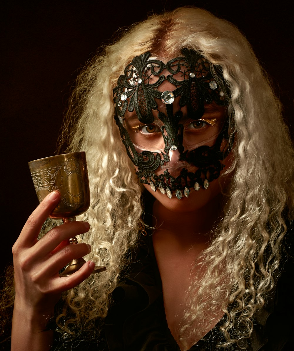 woman in black tank top holding clear drinking glass