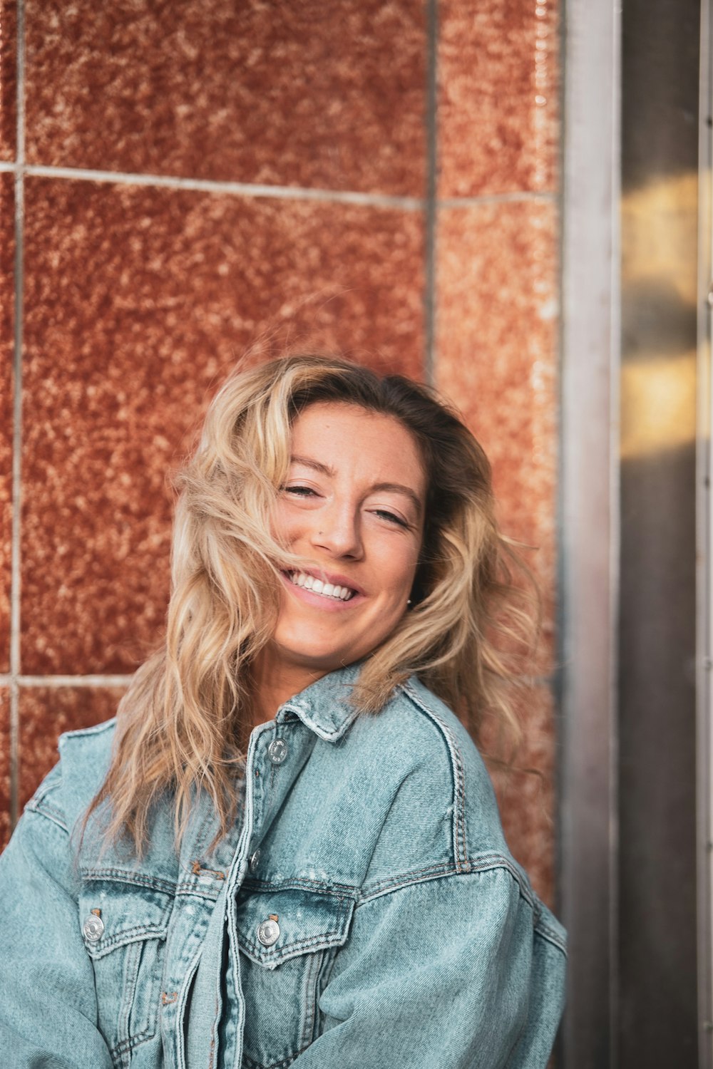 woman in blue denim jacket smiling