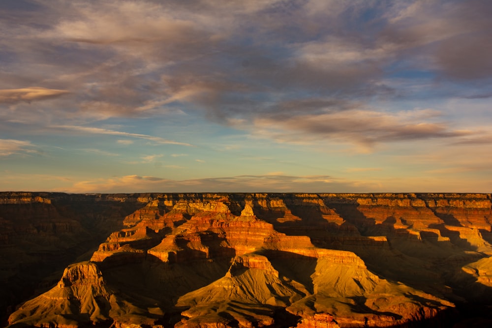 brown rock formation under gray clouds during daytime