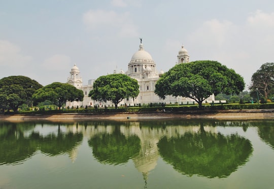 white dome building near green trees and lake during daytime in Maidan India