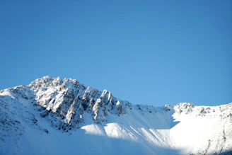 Snow-covered summit towering under a bright, crisp winter day