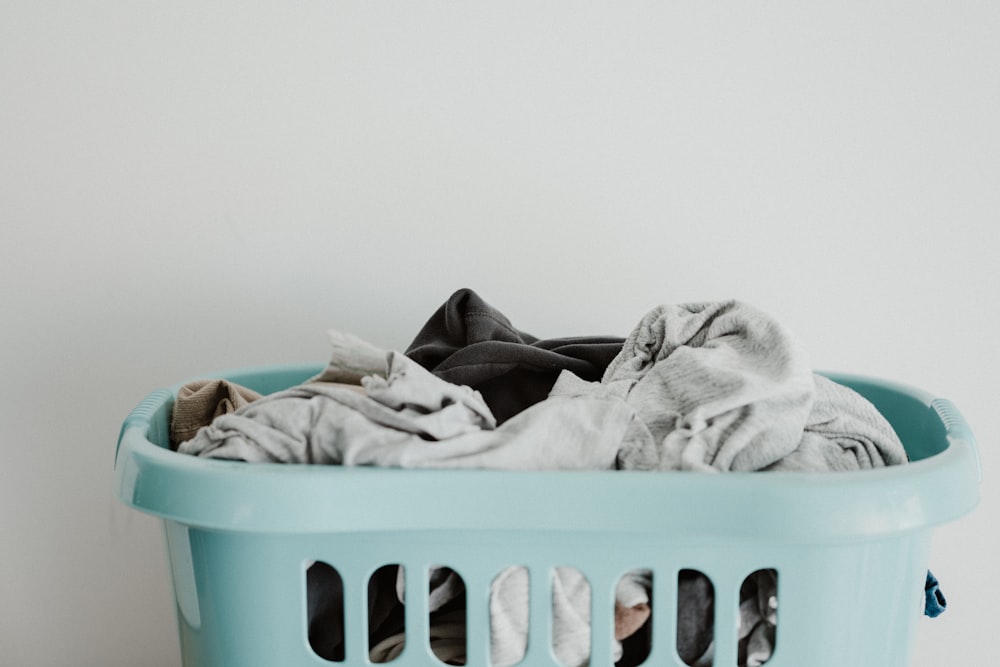 Panier à linge en textile blanc sur plastique bleu