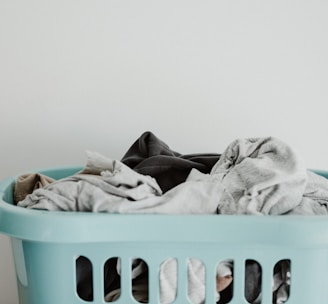 white textile on blue plastic laundry basket