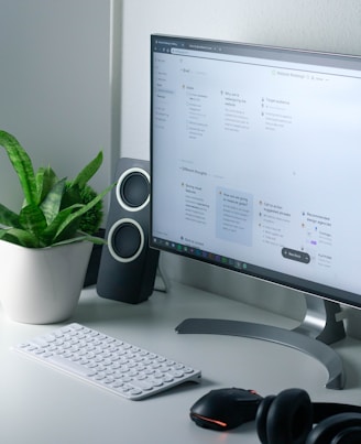 white computer monitor and white keyboard