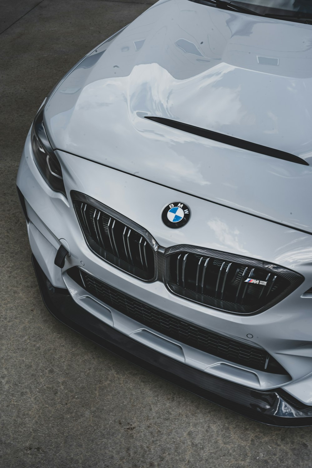 silver bmw car on gray asphalt road