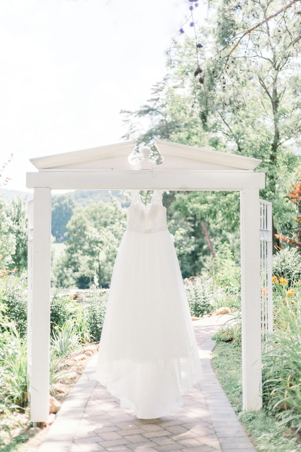 Weißes Hochzeitskleid auf weißem Holzrahmen