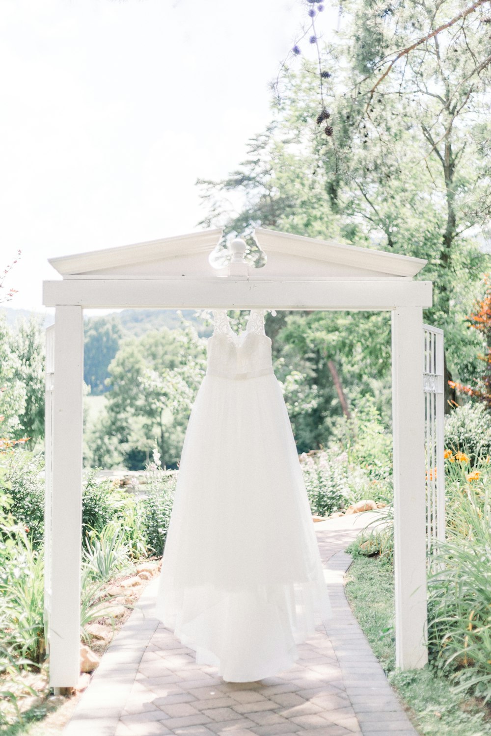 white wedding gown on white wooden frame