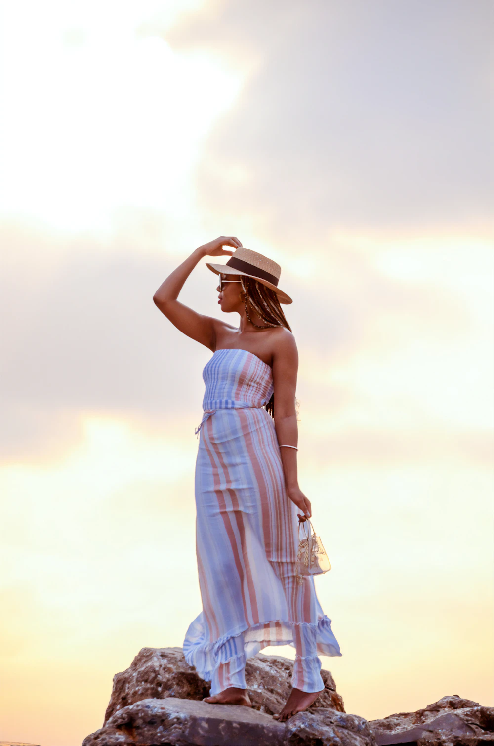 Woman in a white and red plaid dress wearing a black hat