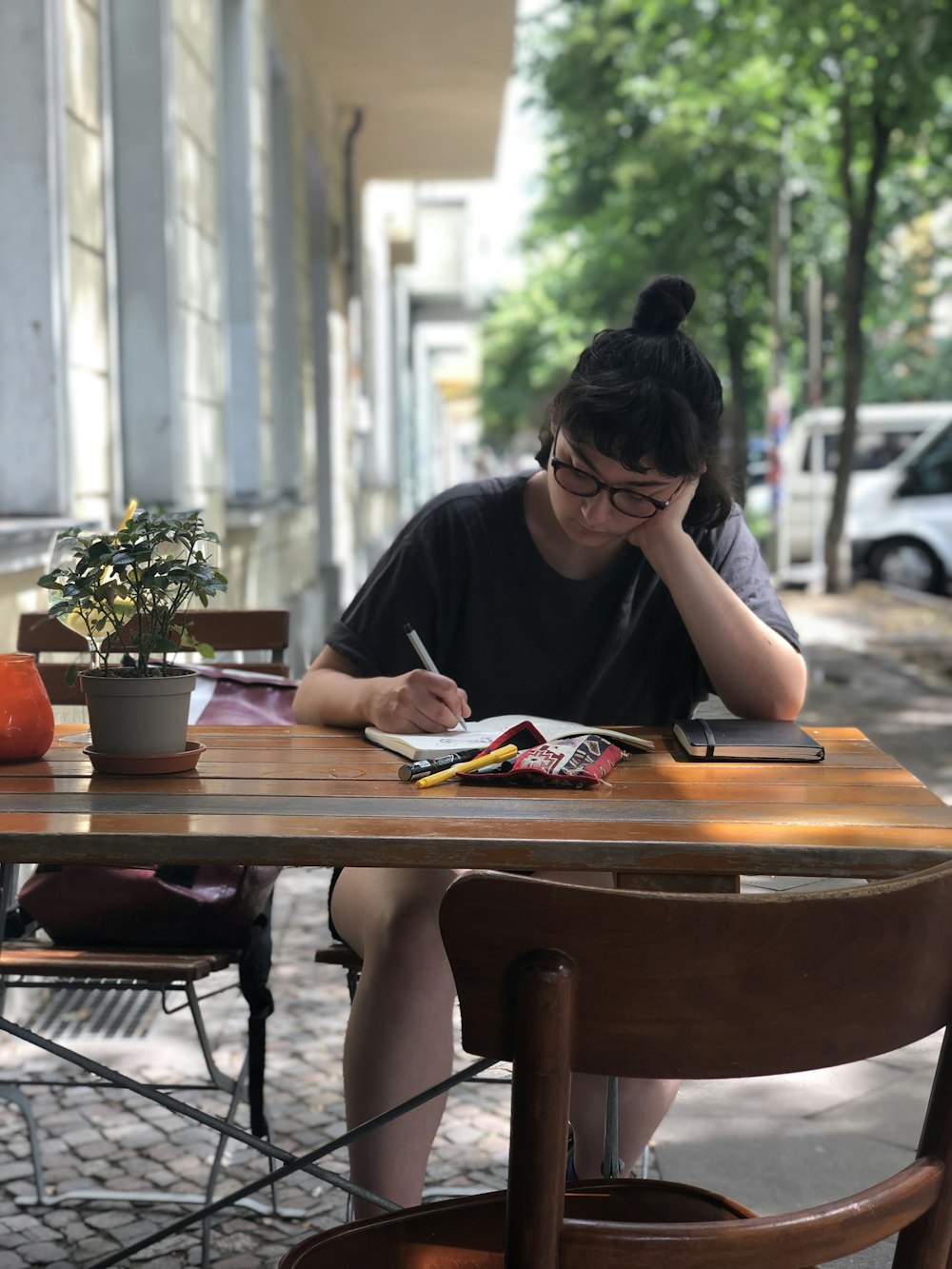 woman in black shirt sitting at the table