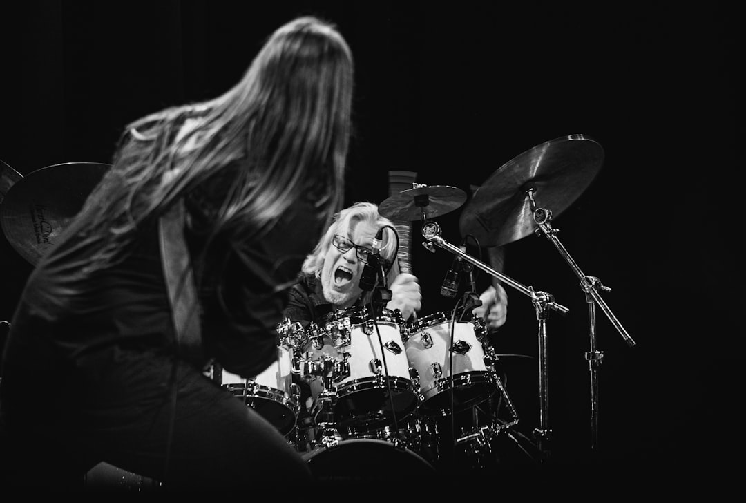 woman in black jacket playing drum set