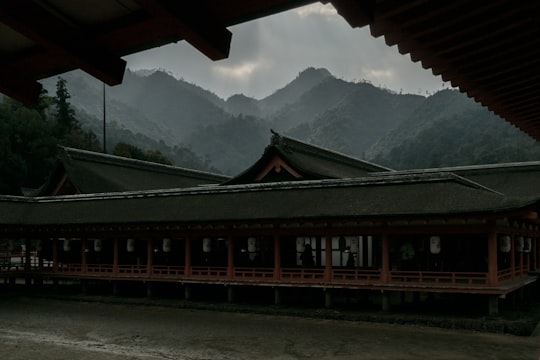 brown wooden house on snow covered ground in Itsukushima Shrine Japan