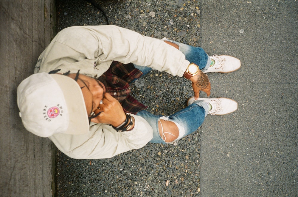 person in brown pants and white sneakers