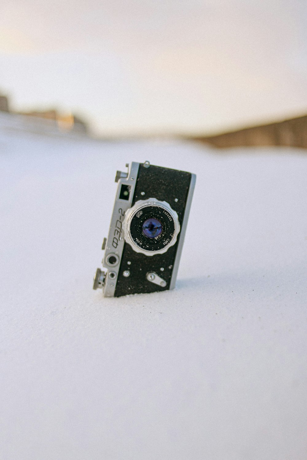 black and gray camera on white surface