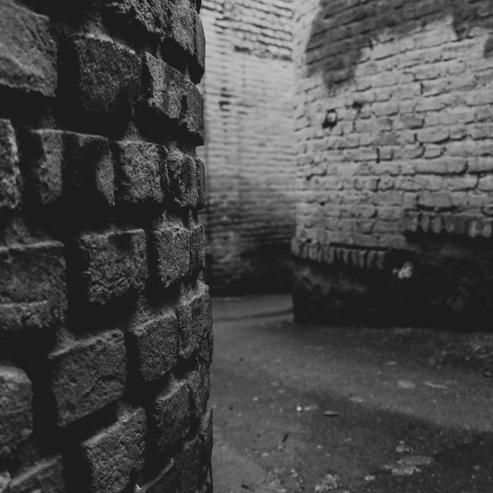 grayscale photo of brick wall