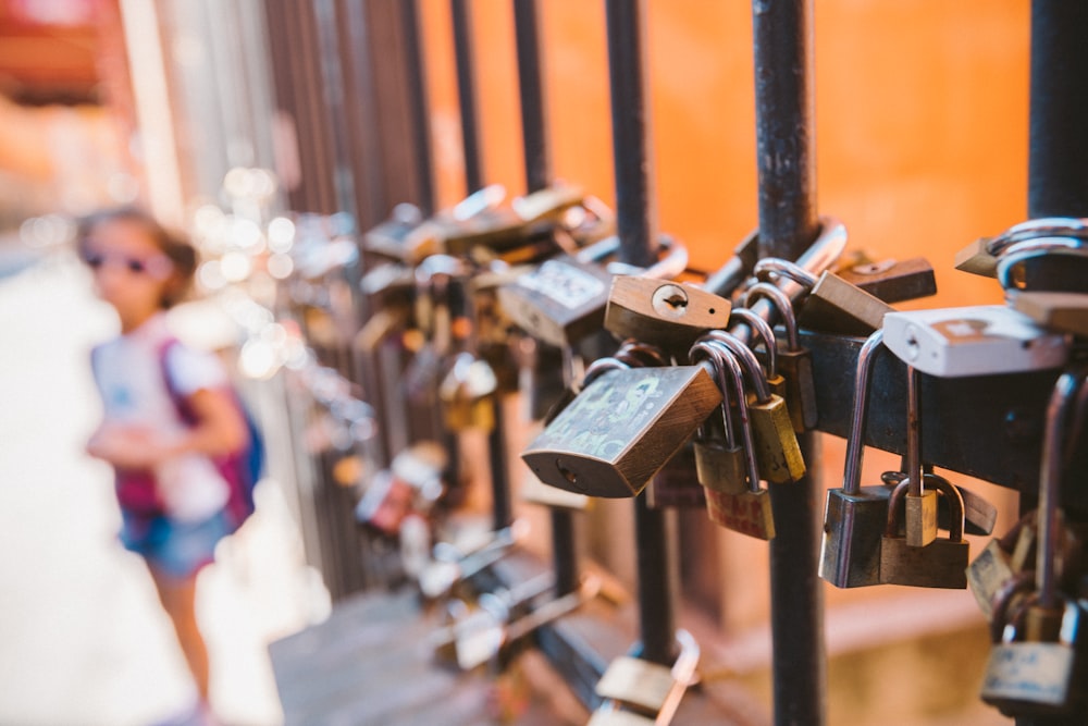 padlock on brown metal fence during daytime