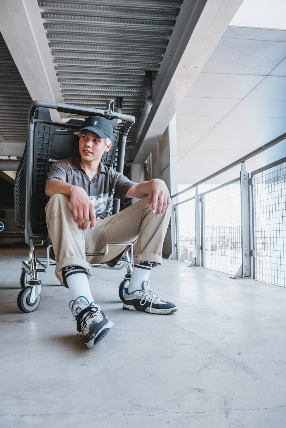 man in blue polo shirt and brown pants sitting on black and silver wheel chair