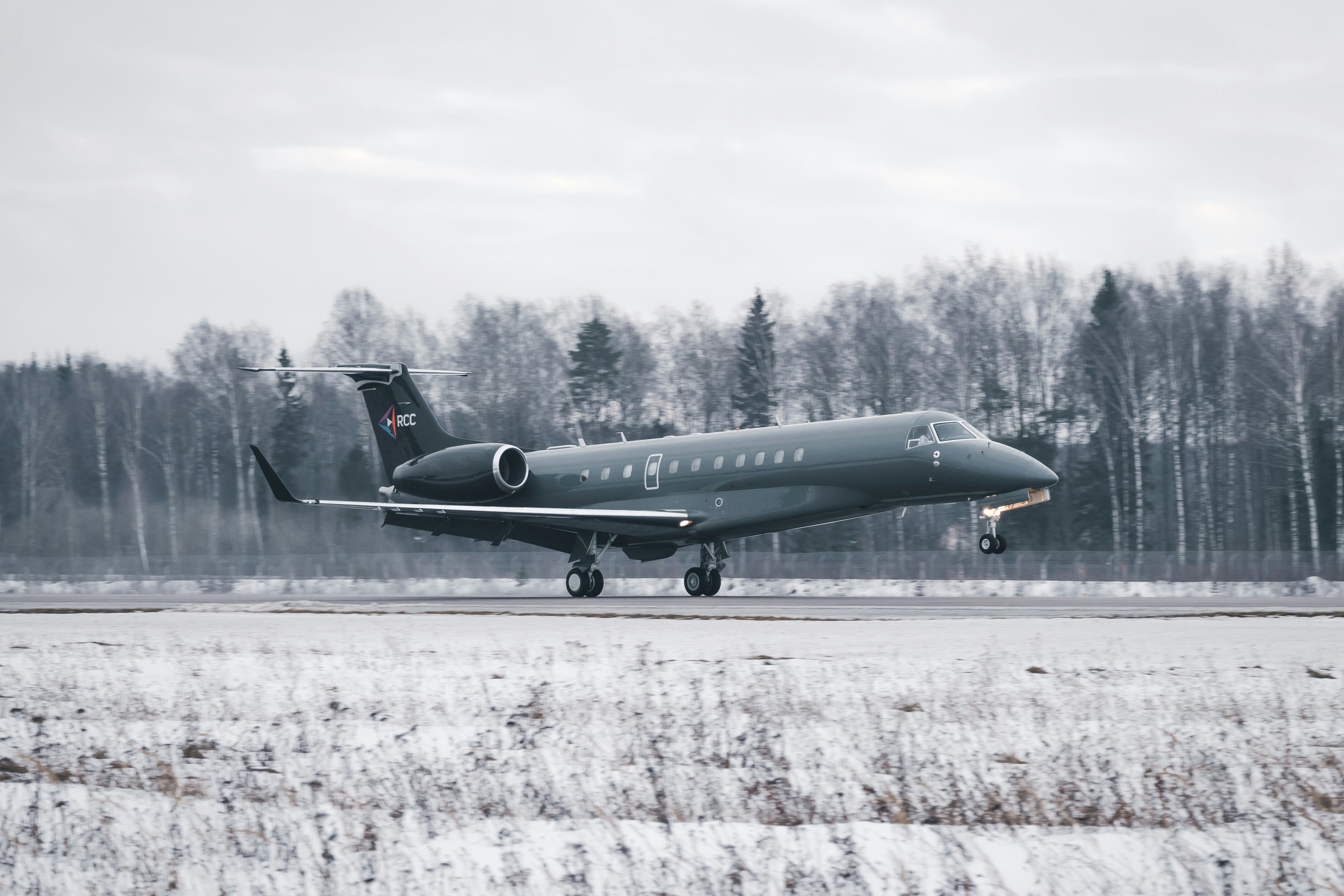 black airplane on white field during daytime