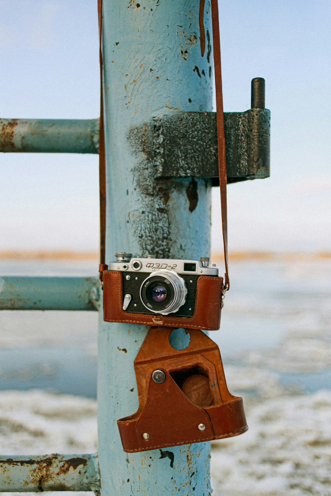 silver and black camera on gray metal bar