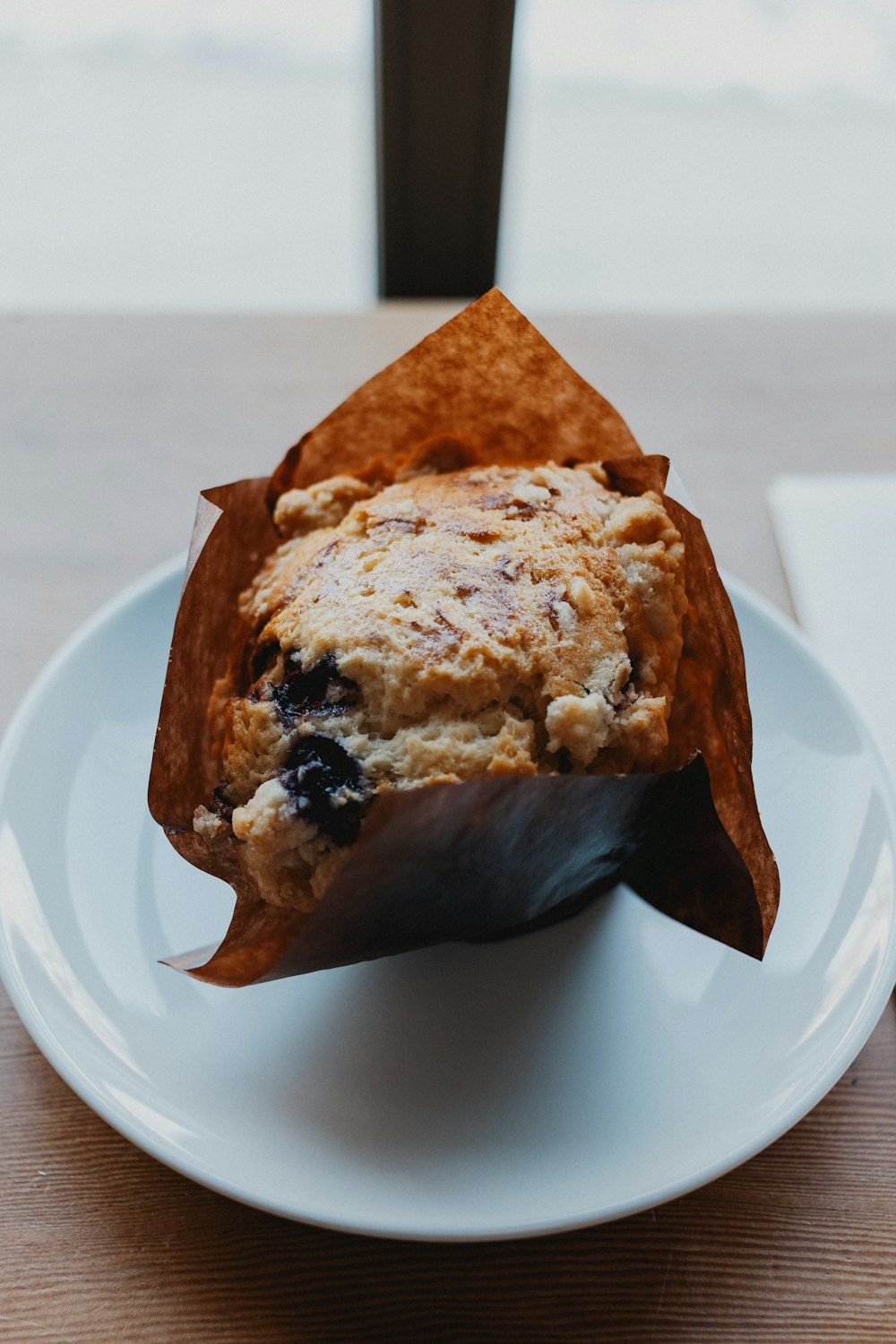 a muffin sitting on top of a white plate