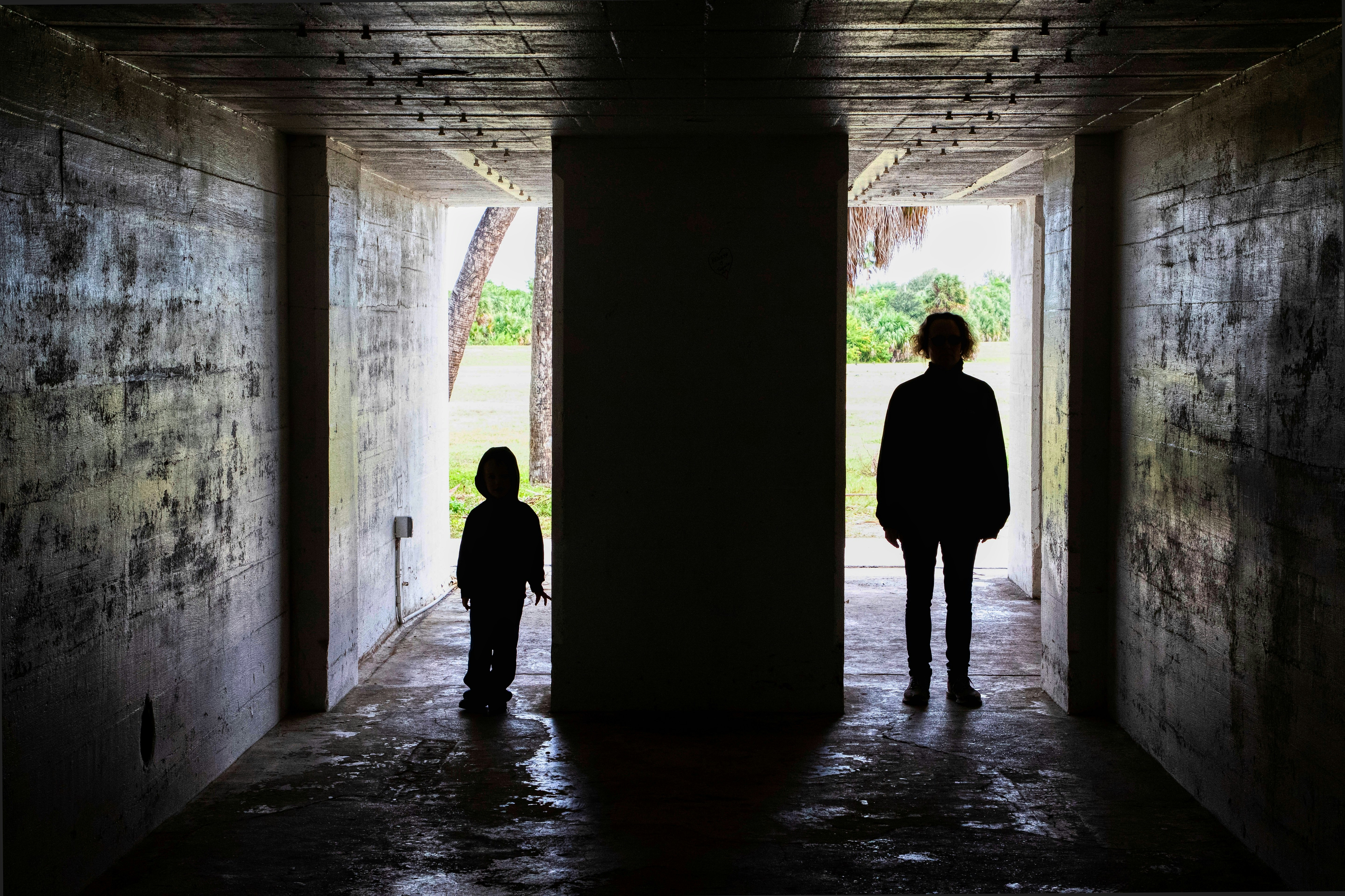 man and woman walking on hallway during daytime