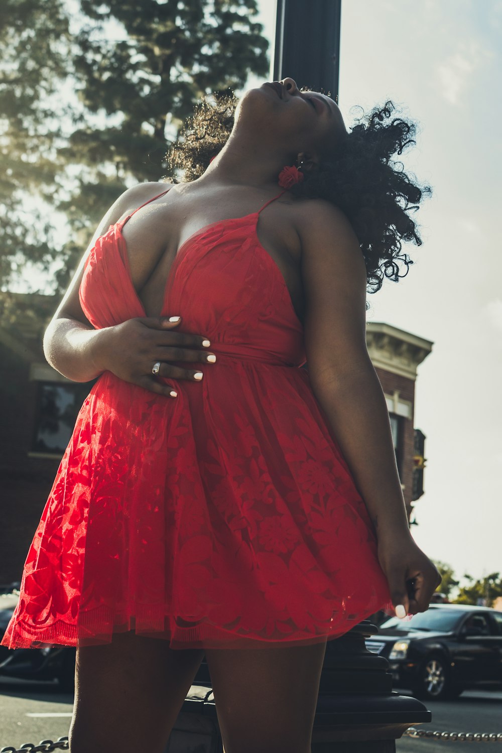 woman in red spaghetti strap dress