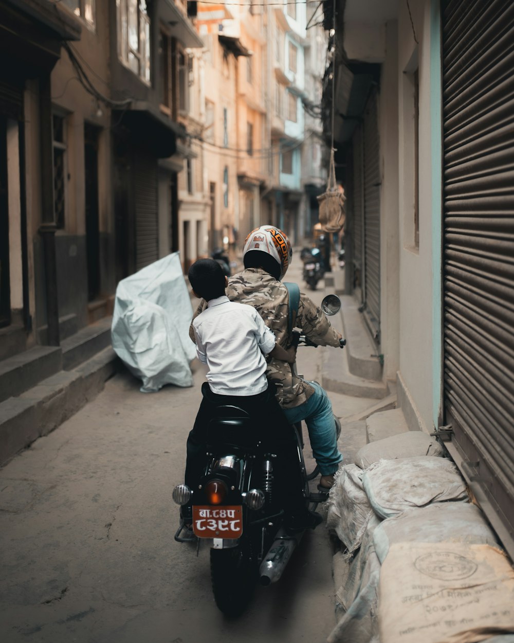 man in white hoodie riding black motorcycle