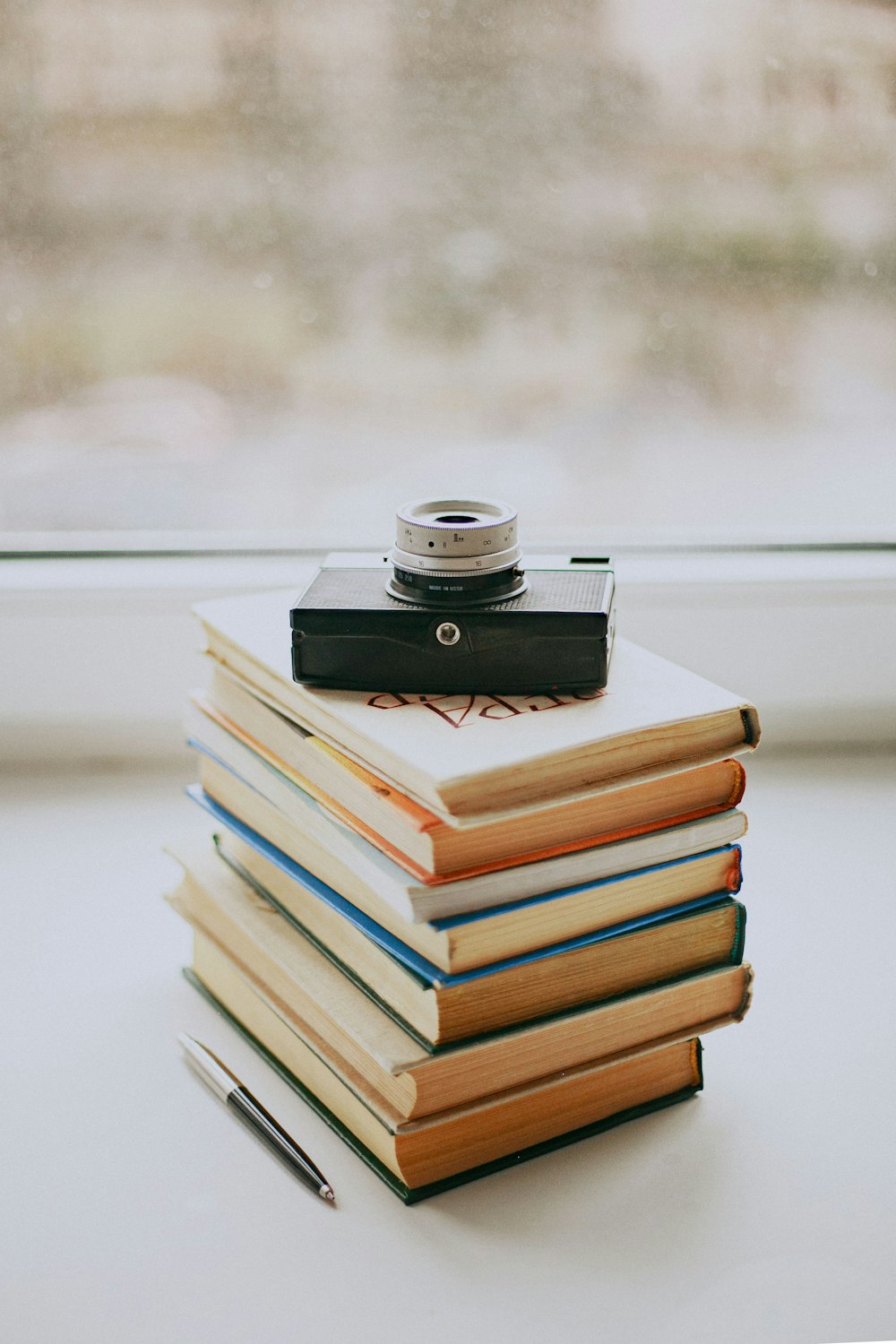 stack of books on white table