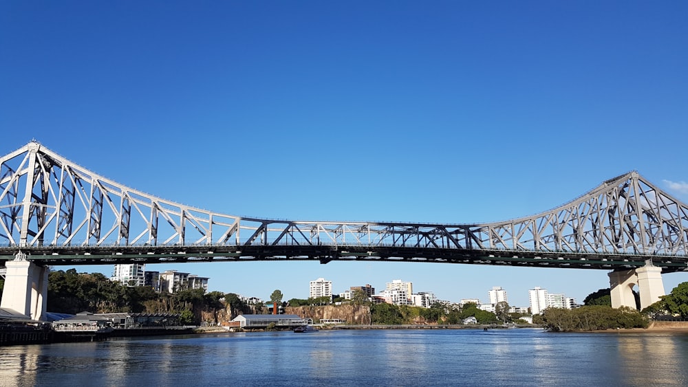 bridge over river under blue sky during daytime