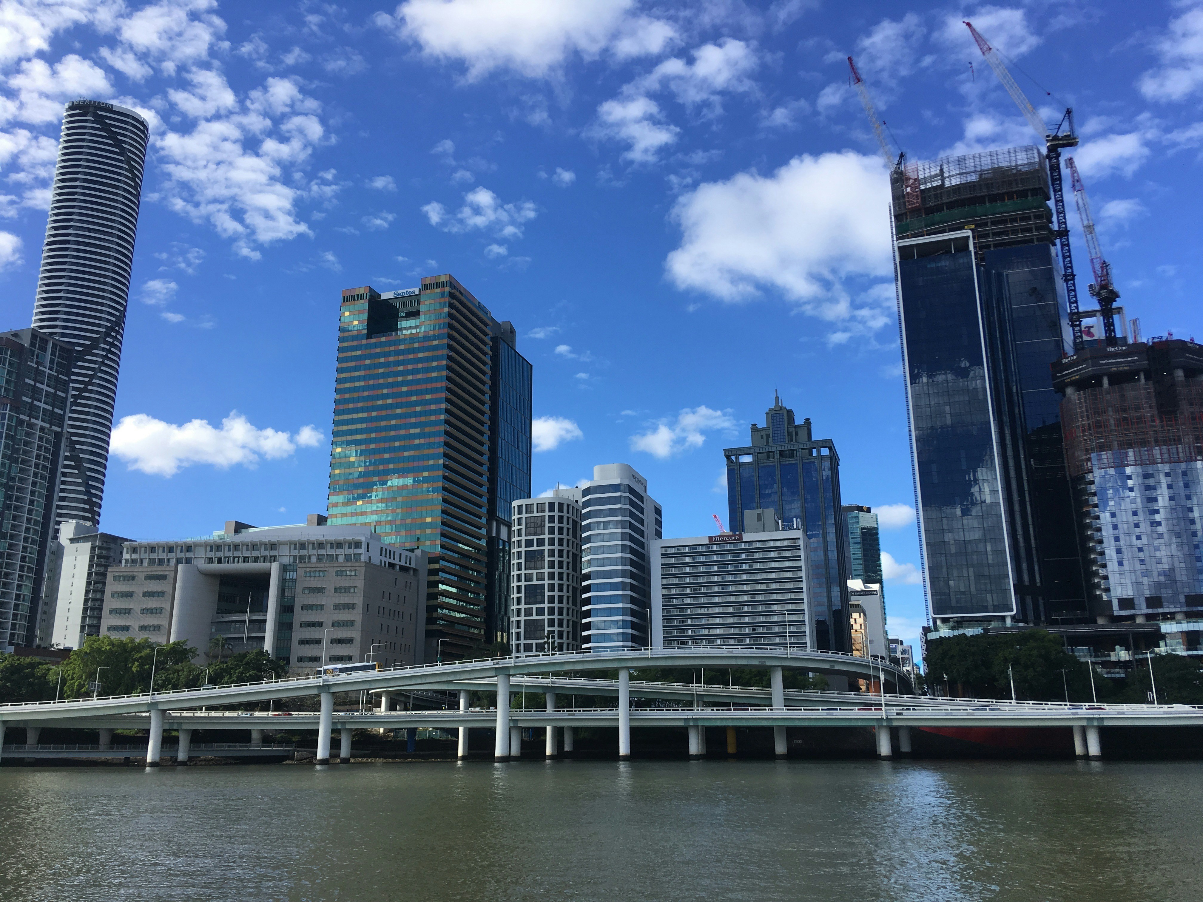 city skyline under blue sky and white clouds during daytime