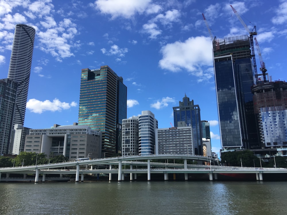 city skyline under blue sky and white clouds during daytime