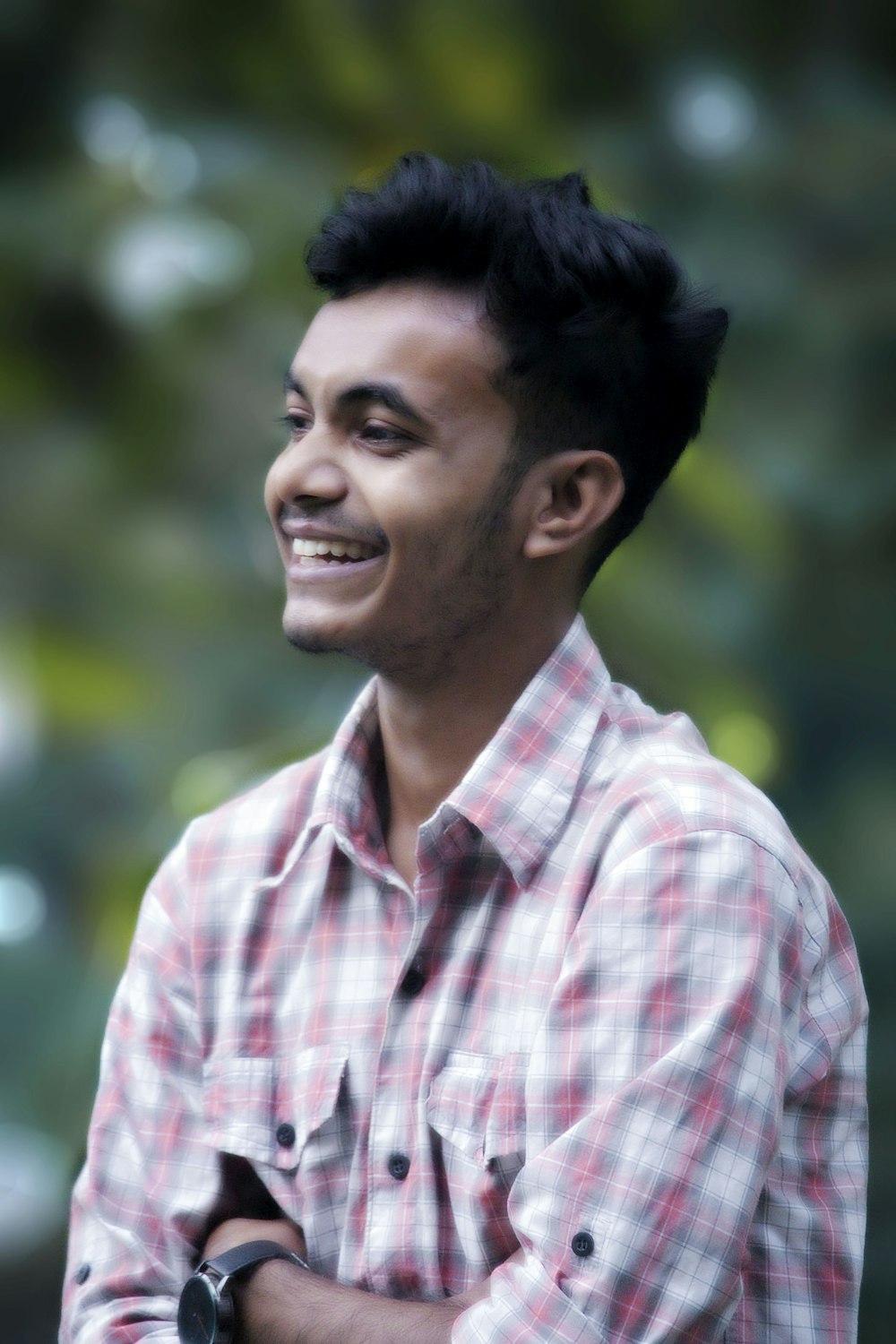 man in white and red plaid button up shirt smiling